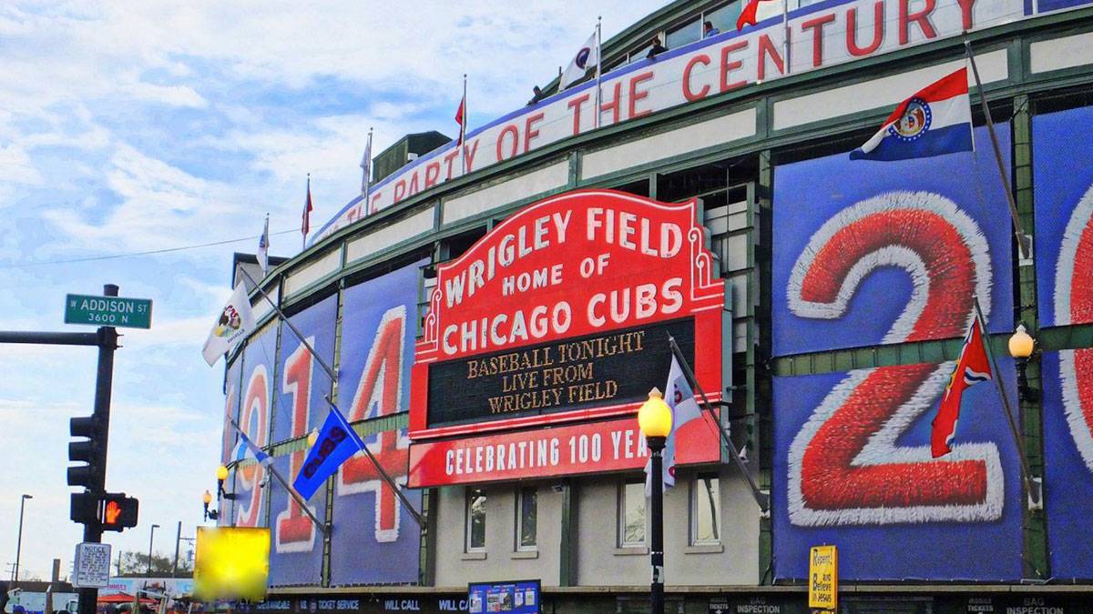 exterior view of wrigley field with crowd of people standing outside in Chicago, Illinois, USA